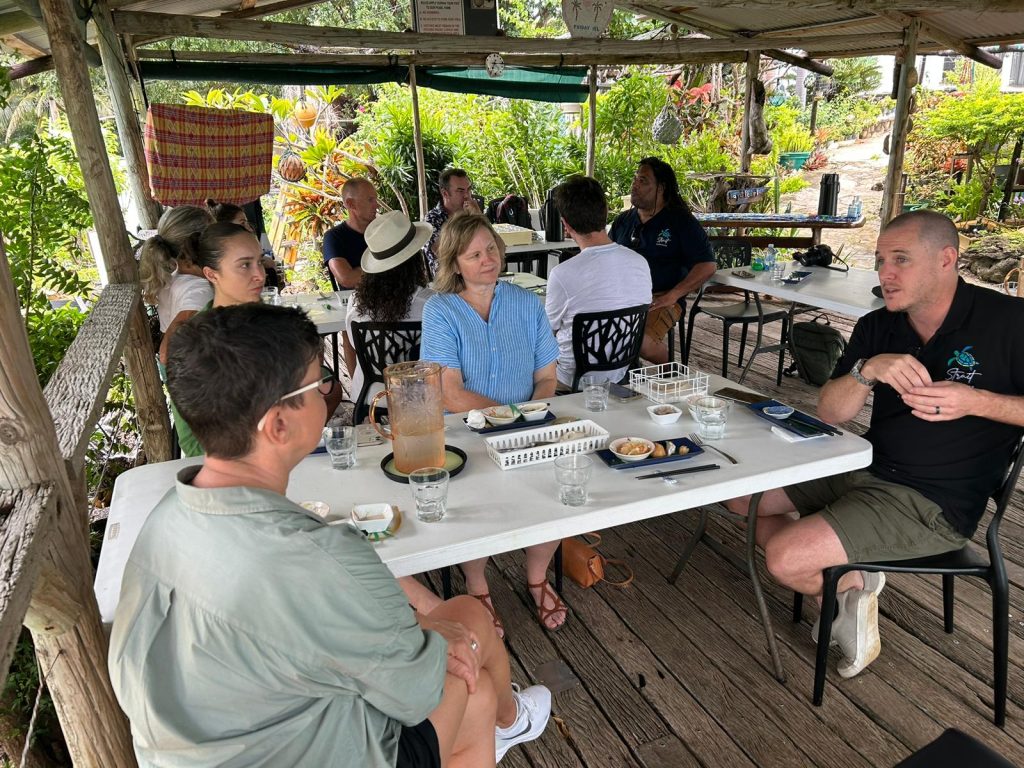 Tables of people talking and enjoying the Strait Experience