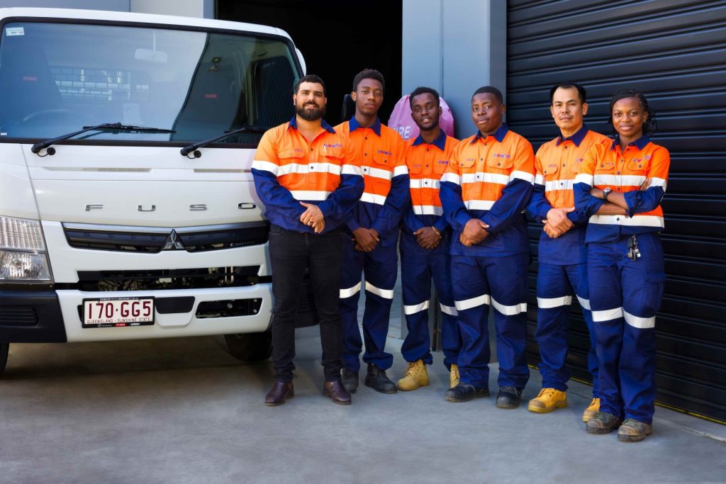 Six members of the Civik team stand in front of a work truck and garage door
