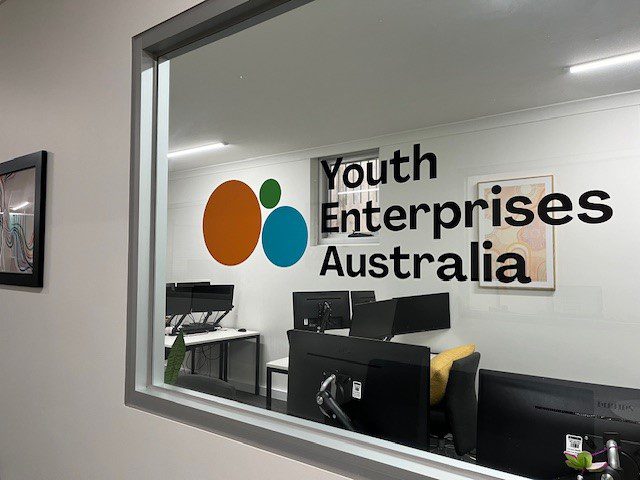 Youth Enterprises Australia name and logo on a window