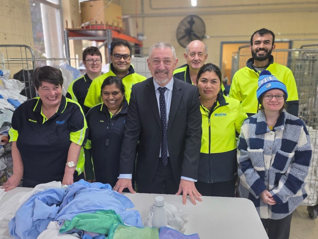 Mark Hunt with some of the crew at the Hobart laundry, including the team from the sewing room.