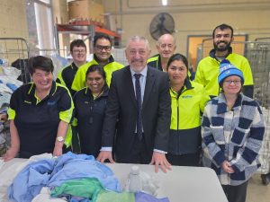 Mark Hunt with some of the crew at the Hobart laundry, including the team from the sewing room.